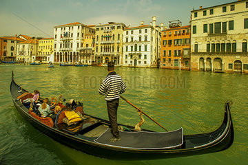 Tourists enjoy a gondola ride on the Grand Canal in Venice  Italy