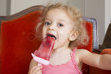 Little girl eating popsicle