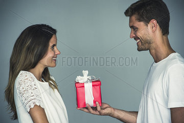 Man giving a gift to his girlfriend