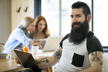 Man using laptop computer  smiling  portrait
