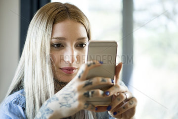 Woman looking at smartphone and smiling