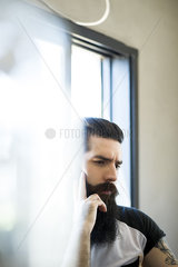 Man thinking with unhappy expression on face
