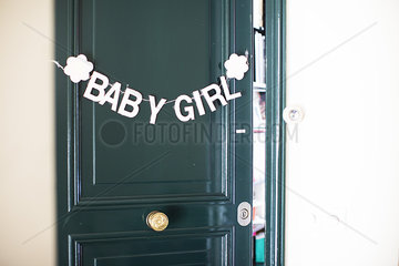 Bunting of baby girl hanging on door