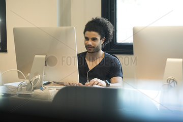 Young man using desktop computer