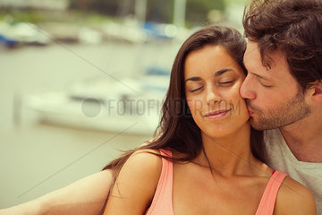 Boyfriend kissing girlfriend on cheek