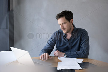 Man using laptop computer in office