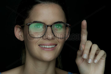 Young woman smiling with finger raised  portrait
