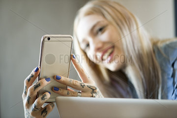 Woman holding smartphone and smiling