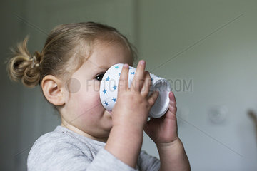 Little girl drinking from cup