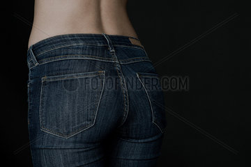 Close-up of woman's rear end in jeans