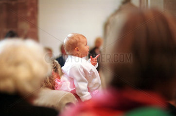 Baby bei einer Konfirmation in einer Saarbrueckener Kirche  Saarland  Deutschland