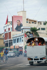 Santiago de Cuba  Kuba  Stadtverkehr  im Hintergrund die Parteizentrale der PCC