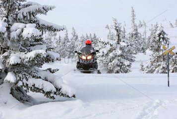 Saelen  Schweden  Mann faehrt auf einem Schneemobil