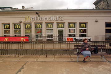 Truebe Stimmung  Frau sitzt vor McDonald's  Magdeburg  Deutschland