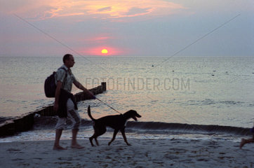 Markgrafenheide  ein Mann mit seinem Hund am Strand