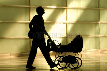 Silhouette eines Vaters mit Kinderwagen