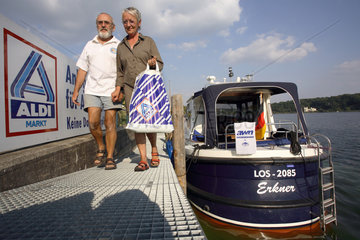 Paar mit Tuete auf Bootsanleger von Aldi in Potsdam