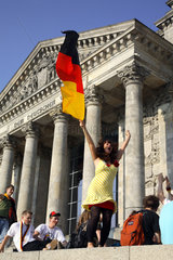 Berlin  Fussballfans WM 2006: Jubelndes Maedchen mit deutscher Fahne vor Reichstag