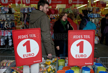 Berlin  Deutschland  Konsumenten hinter Grabbeltischen in einem Ein-Euro-Shop