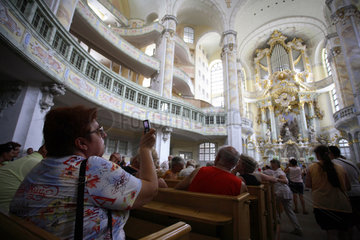 Frau fotografiert mit Handy in der Frauenkirche in Dresden