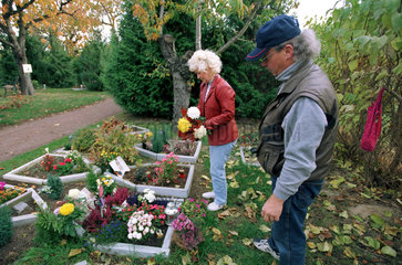 Tierfriedhof: Trauerndes Paar am Grab des Hundes