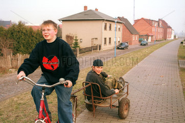 Zwei Jungen mit einem Fahrrad auf dem Deich