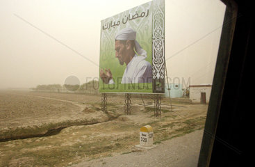Kunduz  Afghanistan  Strassenplakat auf einer Landstrasse
