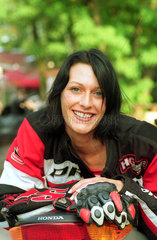 Berlin  Junge Frau mit Motorrad