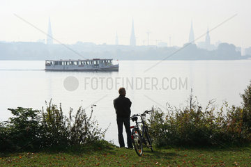 Hamburg  Mann schaut auf Aussenalster mit Faehrschiff
