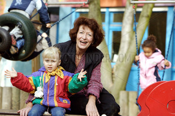 Berlin  eine Grossmutter spielt mit einem Maedchen auf einem Kinderspielplatz