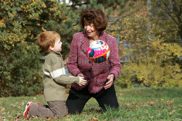 Berlin  eine Grossmutter spielt mit einem Jungen Ball