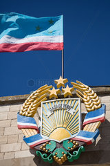 Republik Moldau  Gagausien  Comrat - Das Wappen der Autonomen Region Gagausien auf dem Regierungsgebaeude  sowie die gaugasische Nationalflagge