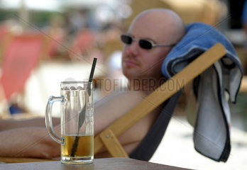 Mann im Schatten mit Bier auf der MONKEY ISLAND in Duesseldorf