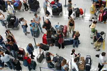 Duesseldorf  Flugreisende warten am Check-In-Schalter