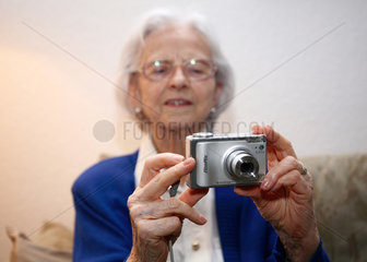 Berlin  Deutschland  eine alte Frau fotografiert mit einer Digitalkamera