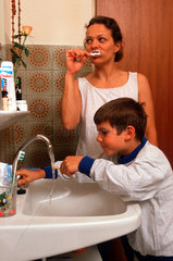 Mutter und Sohn putzen sich die Zaehne