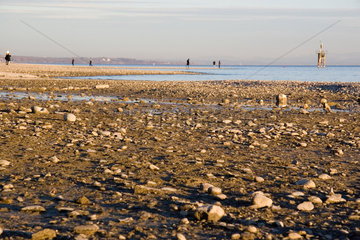 Konstanz  Spaziergaenger am Strand vom Bodensee