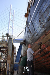 Lehrling bei der Restaurierung eines alten Schiffes in Stralsund