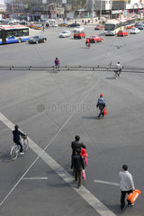 Peking  Menschen ueberqueren eine grosse Kreuzung