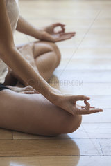Woman seated in yoga lotus position  cropped