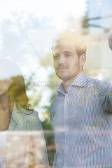 Businessman lost in thought gazing out window