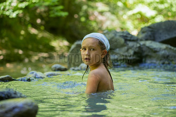 Girl bathing in natural pool