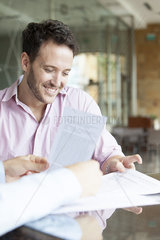 Man reviewing contract with real estate agent