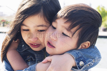 Young siblings embracing