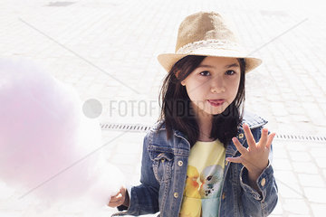 Girl eating cotton candy  portrait