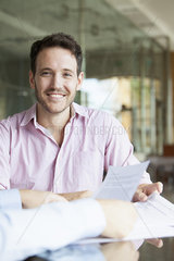 Man reviewing documents with financial advisor
