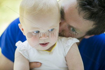 Father nuzzling baby