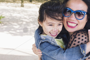 Mother and daughter embracing outdoors  portrait