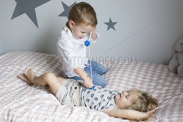 Children playing doctor with toy stethoscope