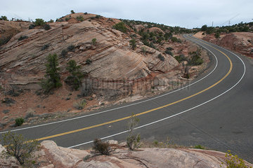 Paved highway through rocky desert landscape